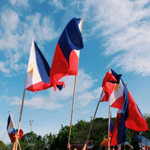low-angle-view-flags-flag-against-sky-1