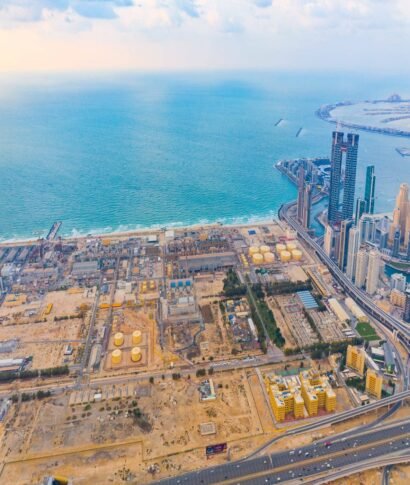 Aerial view of petrochemical oil refinery and sea in industrial engineering and energy concept in Dubai, urban city, UAE. Oil and gas tanks pipelines in industry. Modern metal factory. Power plant.